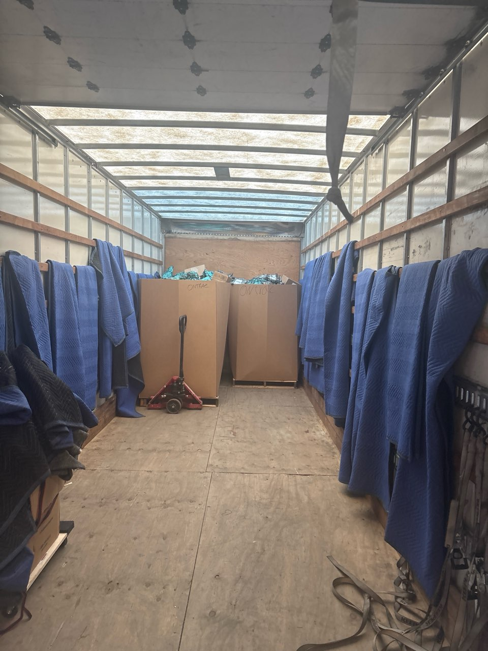Inside a box truck carrying only two pallets at the front, with most of the floor empty.
