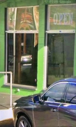 Google Street View image of a green storefront submitted as a proof-of-delivery photo